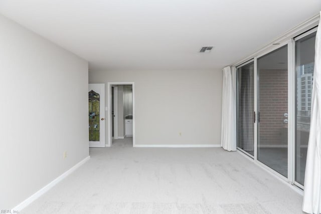 empty room featuring light carpet