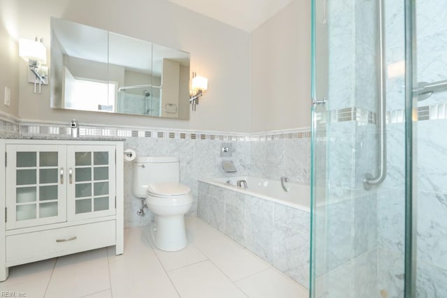 full bathroom with shower with separate bathtub, sink, tile walls, tile patterned flooring, and toilet