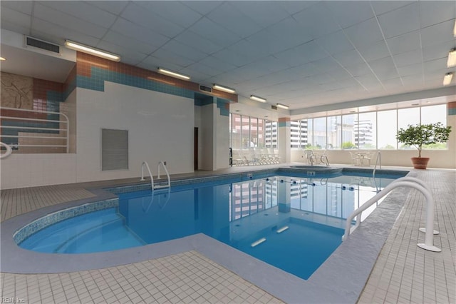 view of swimming pool featuring an indoor hot tub