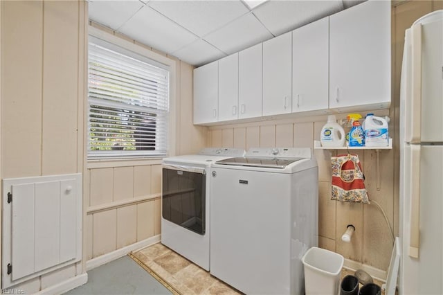 washroom with cabinets and washer and clothes dryer