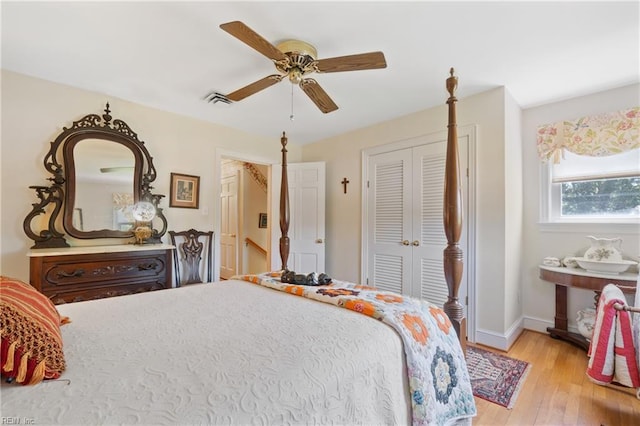 bedroom with ceiling fan, a closet, and light hardwood / wood-style flooring