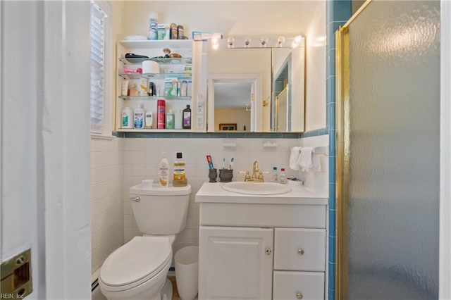 bathroom featuring vanity, toilet, tile walls, and walk in shower