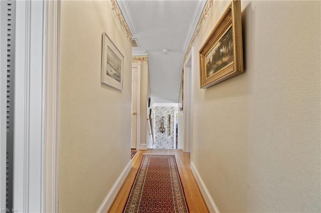 corridor with crown molding and hardwood / wood-style flooring