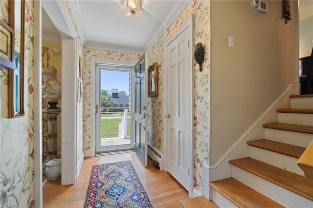 entryway featuring baseboard heating, crown molding, and light hardwood / wood-style flooring