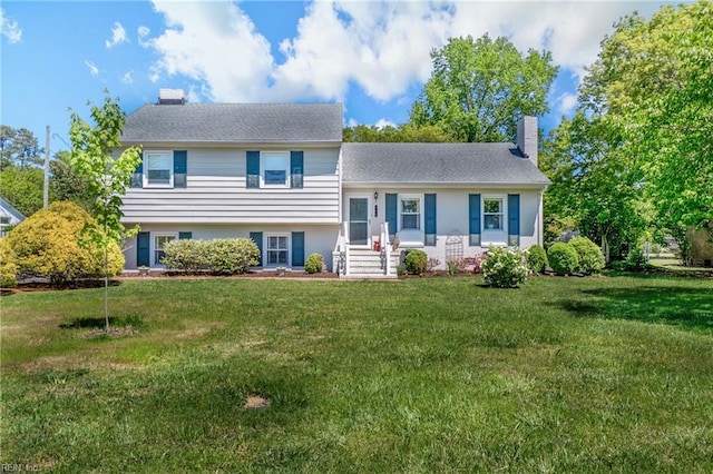 tri-level home with a front yard