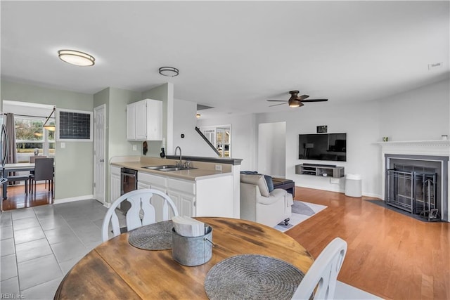 dining room with ceiling fan, sink, and tile patterned floors