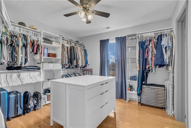 spacious closet with ceiling fan and light hardwood / wood-style floors