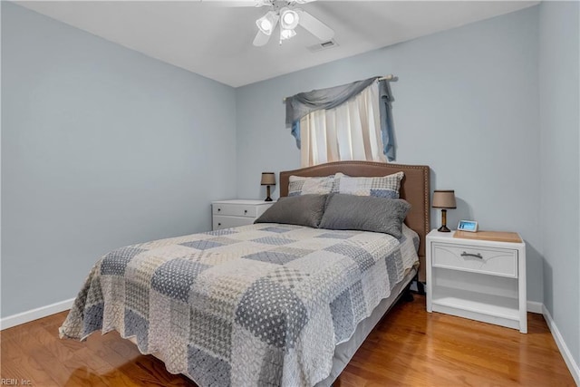 bedroom with ceiling fan and hardwood / wood-style flooring