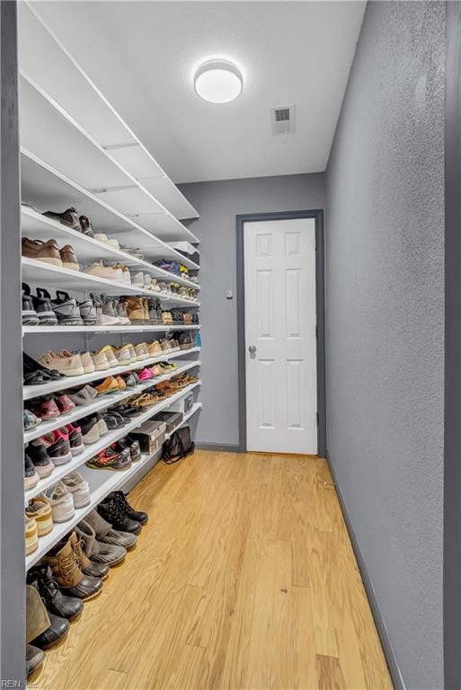 walk in closet featuring hardwood / wood-style flooring