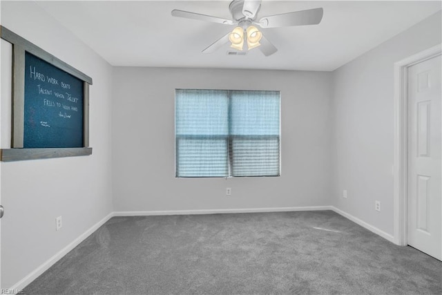 carpeted spare room featuring ceiling fan