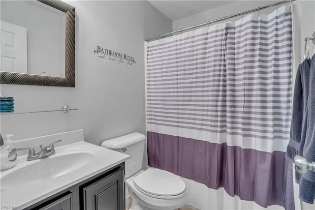 bathroom featuring toilet and vanity