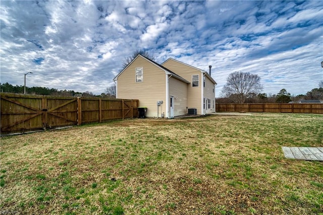 exterior space featuring a lawn and central air condition unit