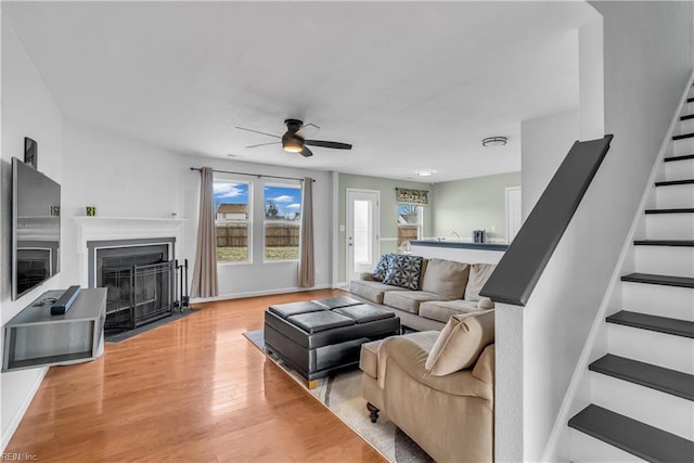 living room with ceiling fan and light hardwood / wood-style floors