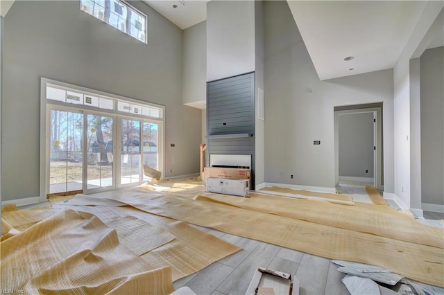 unfurnished living room with french doors and a high ceiling