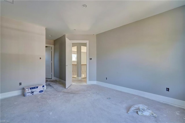 spare room featuring concrete flooring