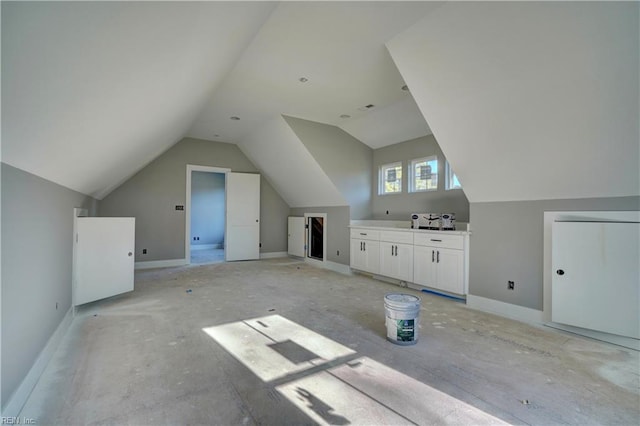 additional living space featuring vaulted ceiling