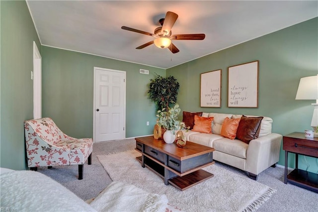 carpeted living room with ceiling fan