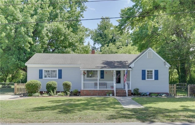 ranch-style home featuring a front yard and a porch