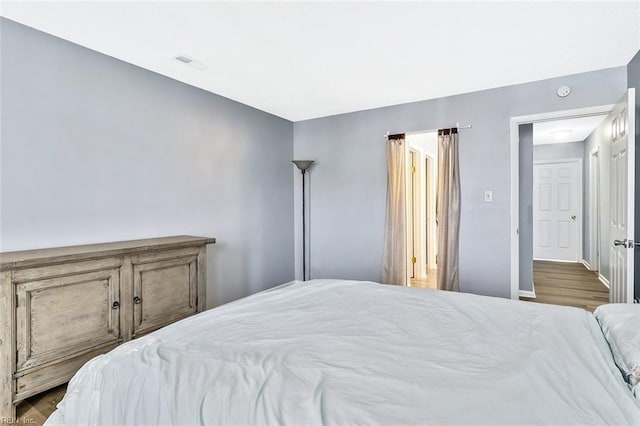 bedroom with wood-type flooring