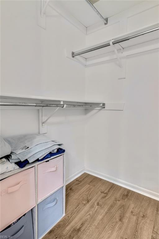 spacious closet featuring light hardwood / wood-style floors