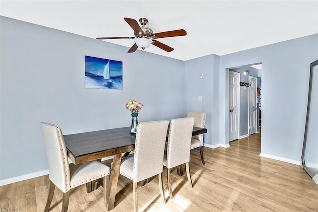 dining area featuring ceiling fan and light hardwood / wood-style flooring