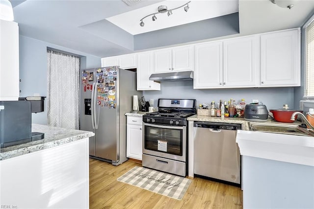 kitchen featuring sink, stainless steel appliances, light hardwood / wood-style floors, and white cabinets