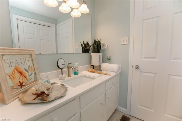 bathroom featuring a chandelier and vanity