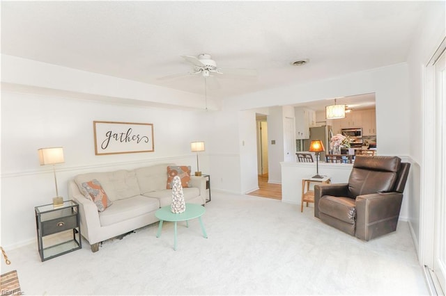 carpeted living room featuring ceiling fan