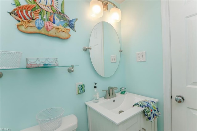 bathroom with toilet and vanity