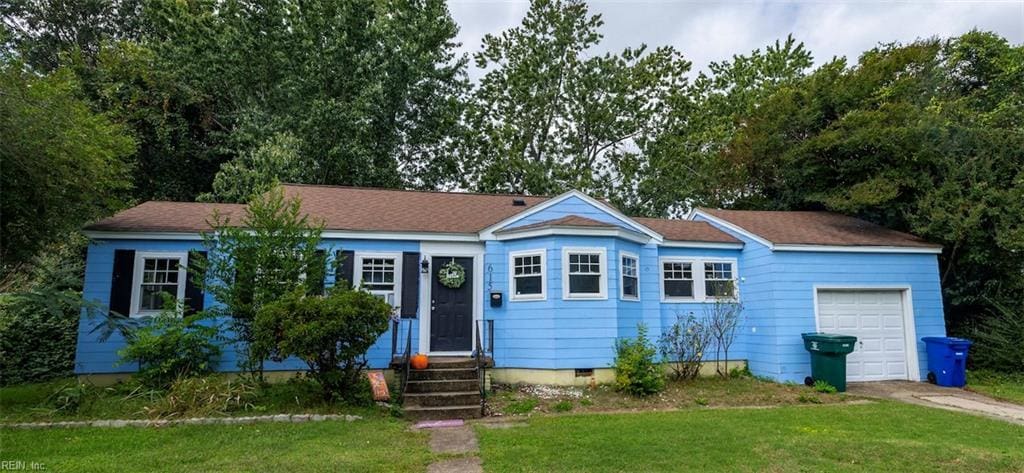 ranch-style home with a garage and a front lawn