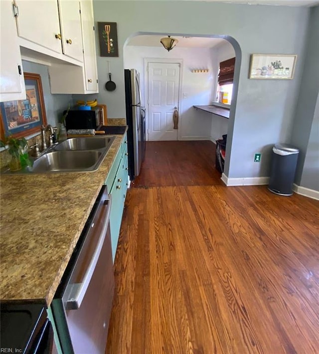 kitchen with dark wood-type flooring, sink, white cabinetry, and stainless steel appliances