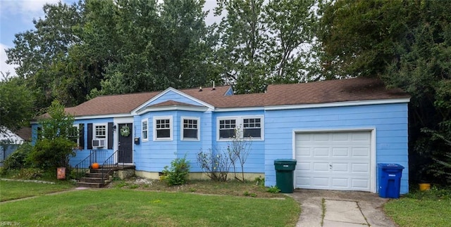 ranch-style house featuring a garage, cooling unit, and a front lawn