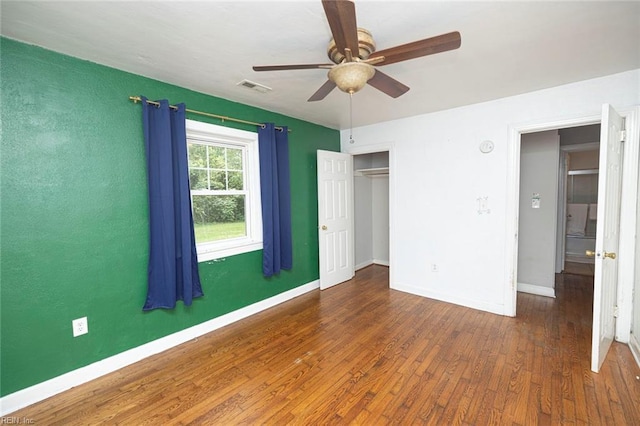 unfurnished bedroom featuring ceiling fan and dark wood-type flooring