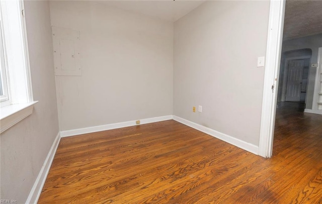 spare room with dark hardwood / wood-style flooring