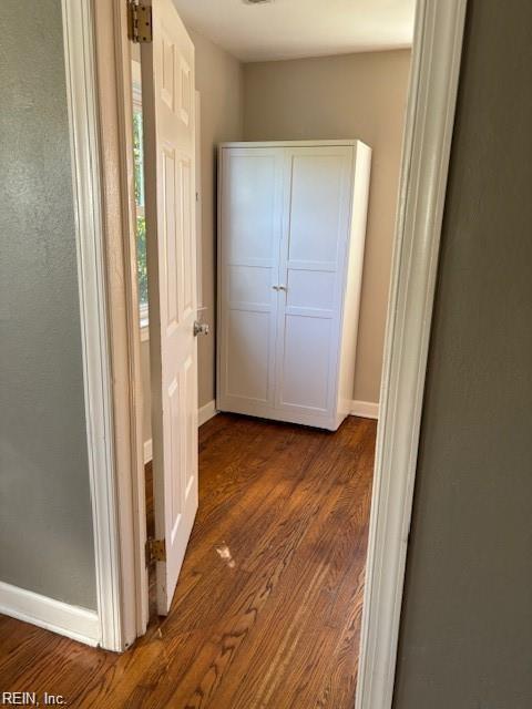 hallway with dark wood-type flooring