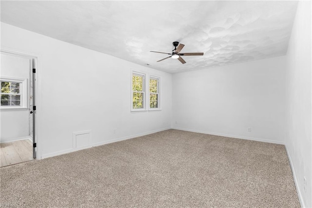 unfurnished room featuring light carpet and ceiling fan