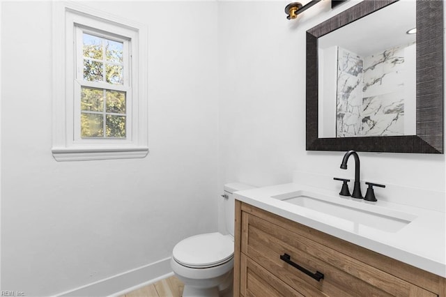 bathroom with toilet and vanity