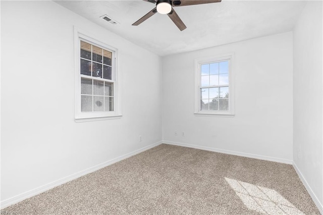 spare room featuring ceiling fan and carpet