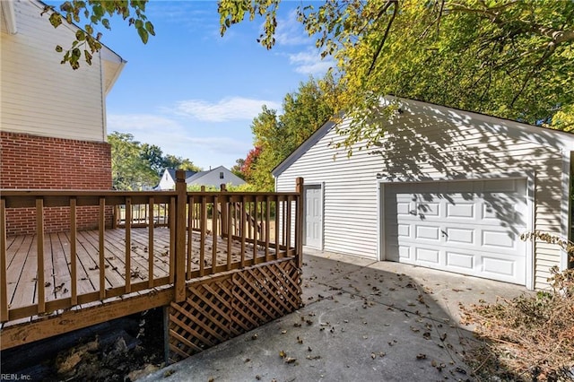 wooden deck with a garage and an outdoor structure