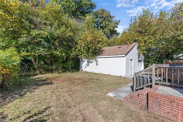 view of yard featuring a deck and an outdoor structure