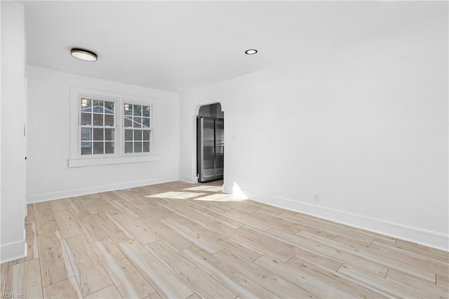 spare room featuring light hardwood / wood-style flooring