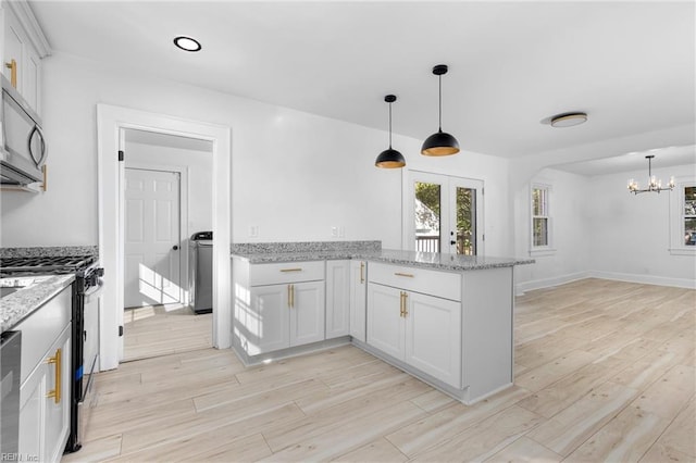 kitchen featuring white cabinetry, kitchen peninsula, light wood-type flooring, hanging light fixtures, and light stone countertops