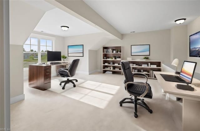 carpeted office space with beamed ceiling