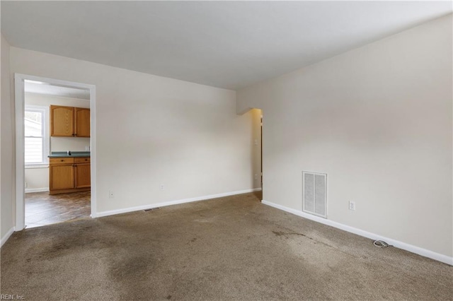 empty room featuring dark carpet