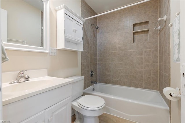 full bathroom featuring vanity, tile patterned floors, toilet, and tiled shower / bath