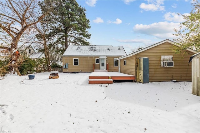 snow covered property with a wooden deck