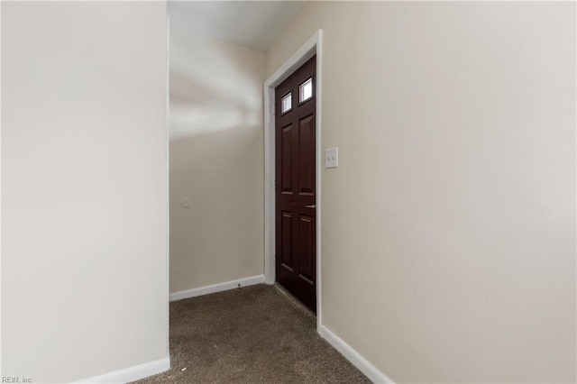 doorway with dark colored carpet