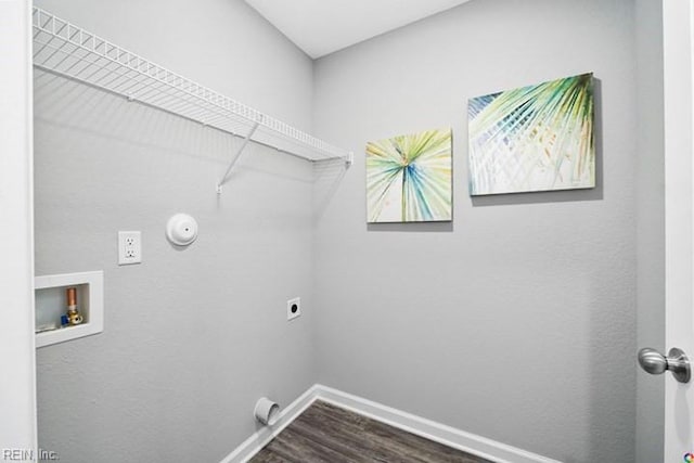 washroom featuring dark hardwood / wood-style flooring, washer hookup, hookup for an electric dryer, and gas dryer hookup