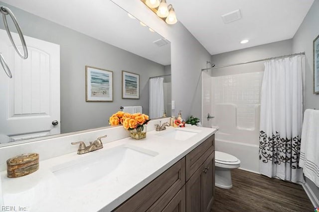 full bathroom with toilet, vanity, wood-type flooring, and shower / bath combination with curtain