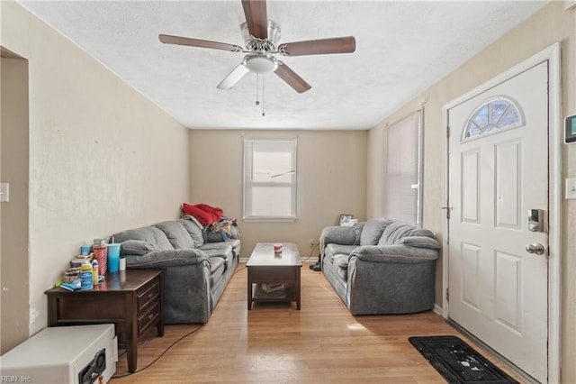 living room with ceiling fan and light hardwood / wood-style floors